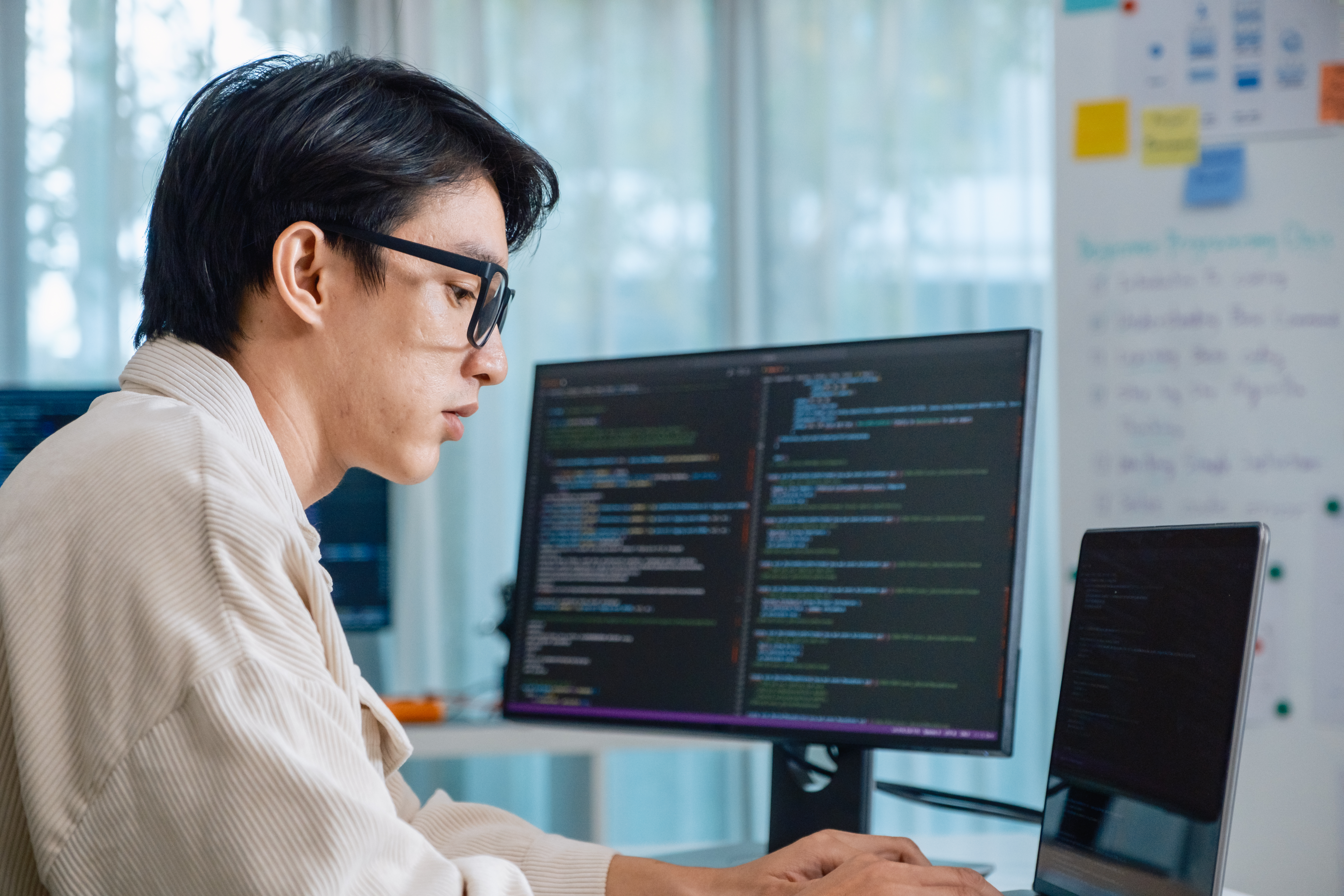 Developer software programmer computer coding screen working technology engineering monitor at modern workspace